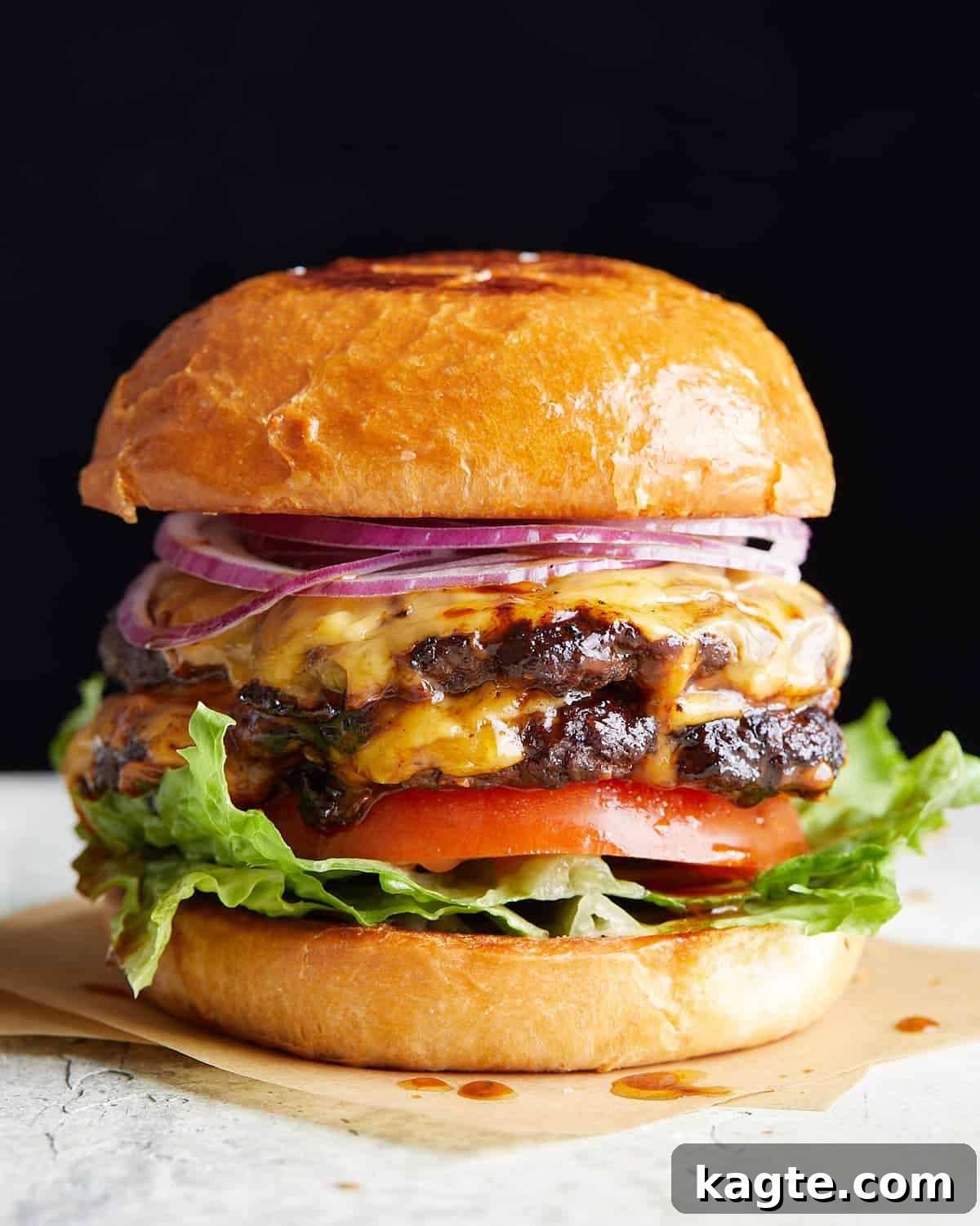 Side profile picture of a hamburger patty with garnish. 