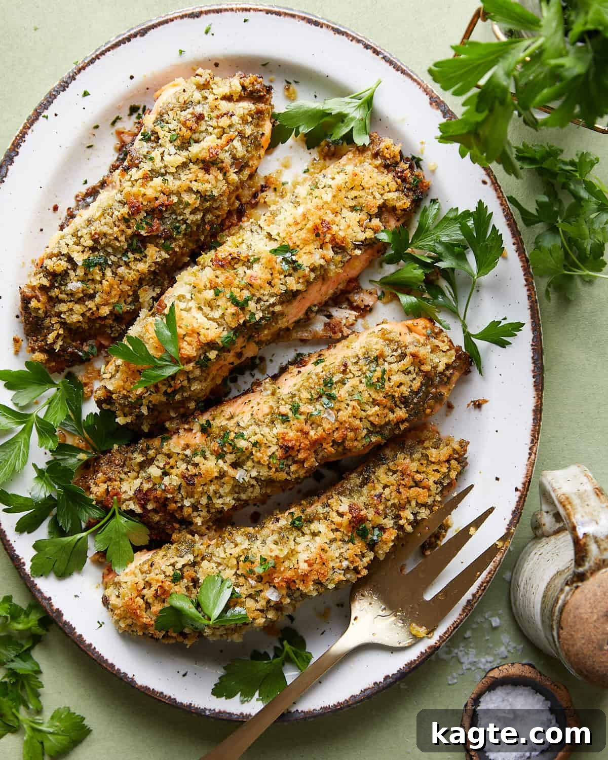 Crispy Pesto Salmon with Lemon Garlic Panko 2 Overhead image of pesto crusted salmon with garlic lemon panko, garnished with fresh lemon wedges and herbs.