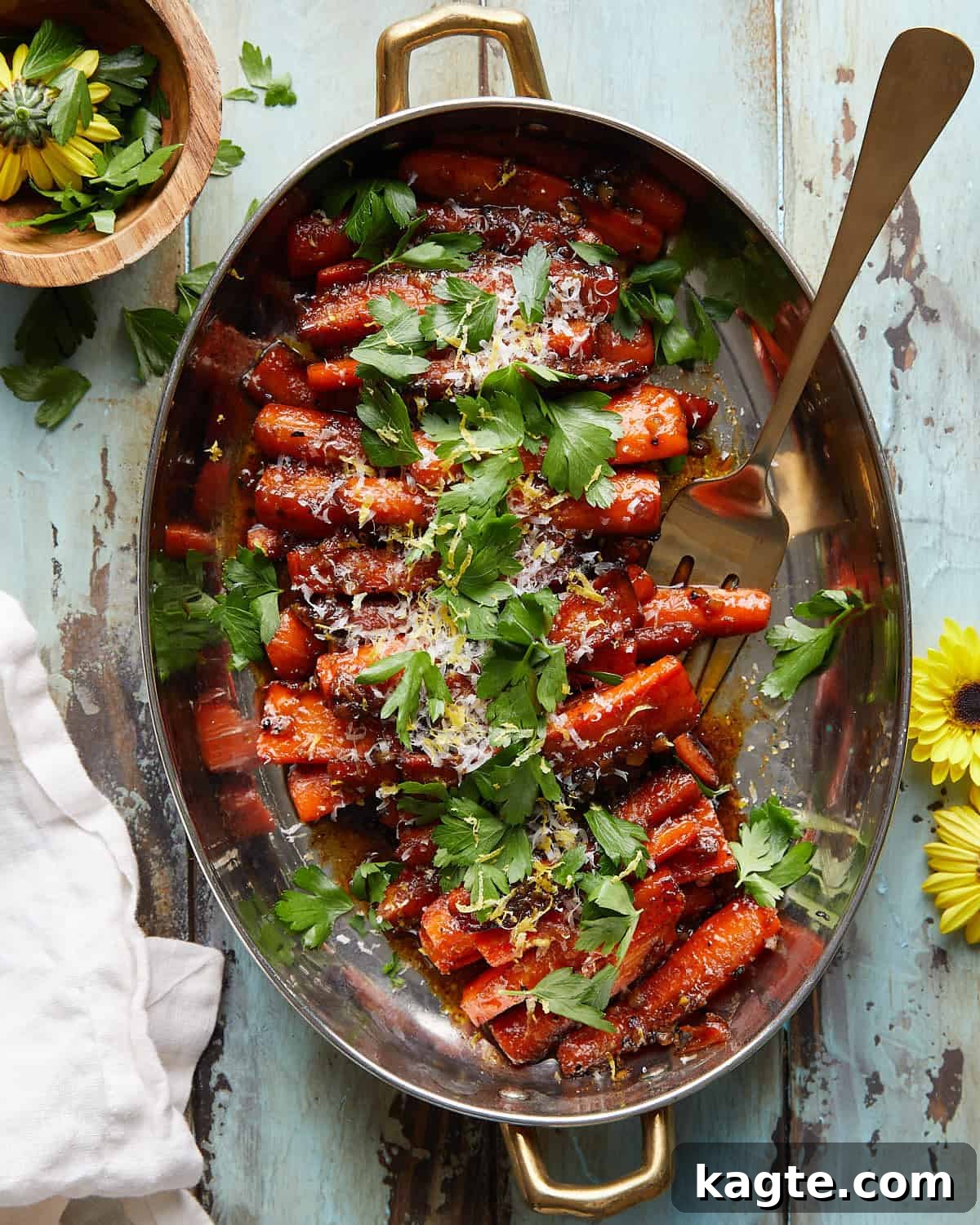 Overhead view of perfectly glazed stovetop carrots, garnished with fresh herbs, ready to be served.
