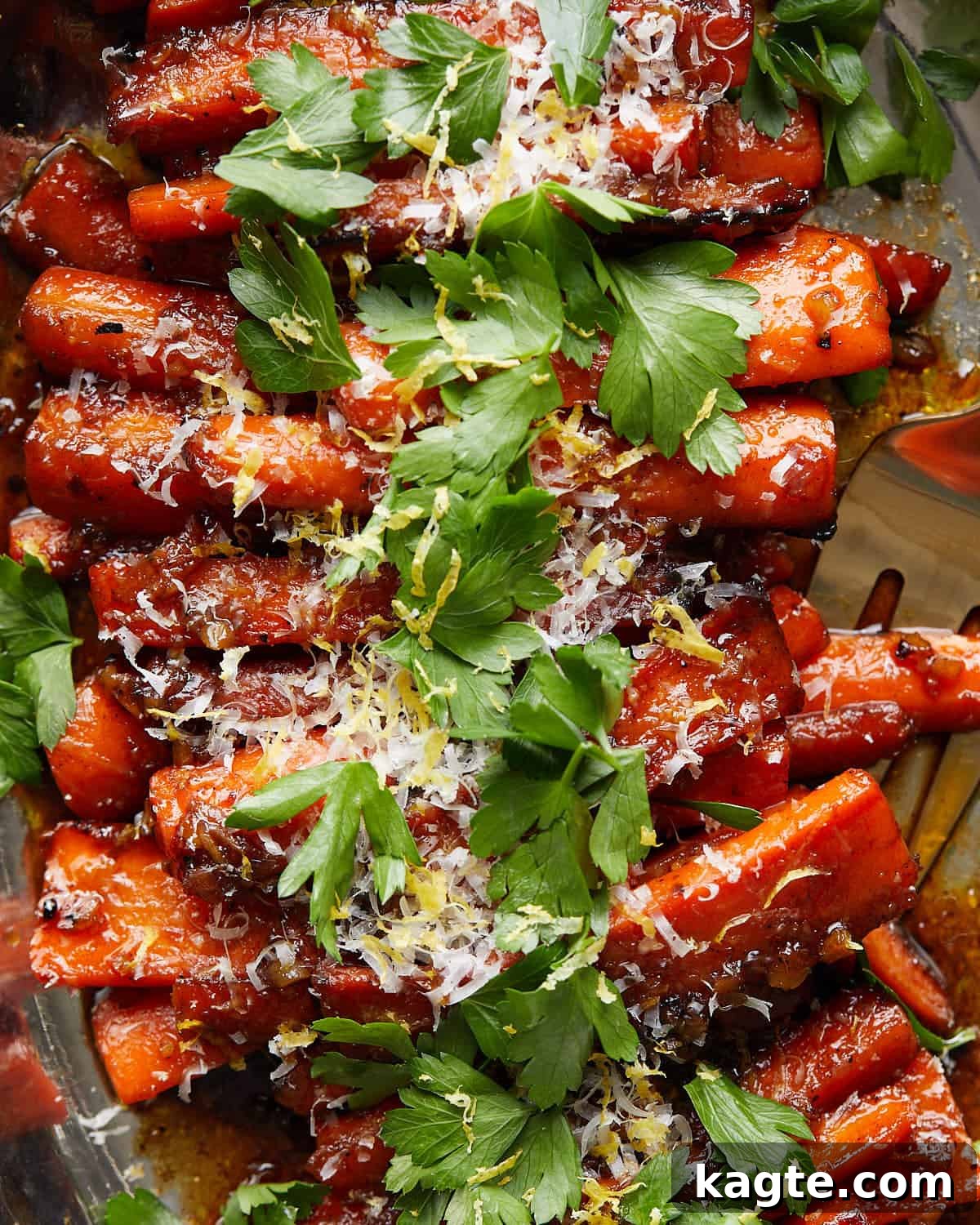 Close-up shot of individual glazed stovetop carrots, showing their tender texture and the glistening honey-cheese glaze.