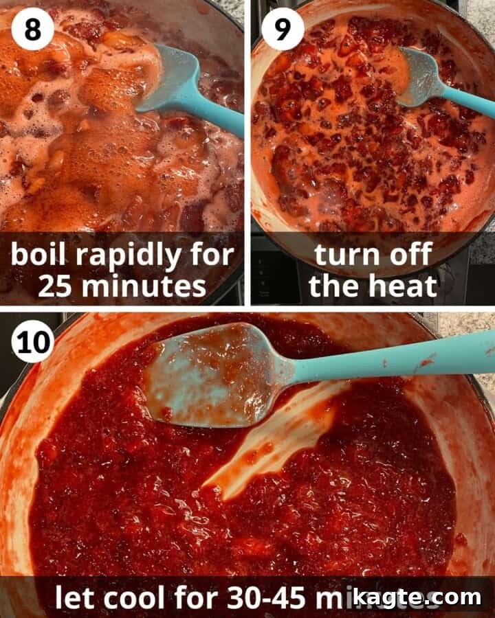 Strawberry preserves boiling vigorously in a stainless steel pot, showing a thick, bubbling texture.