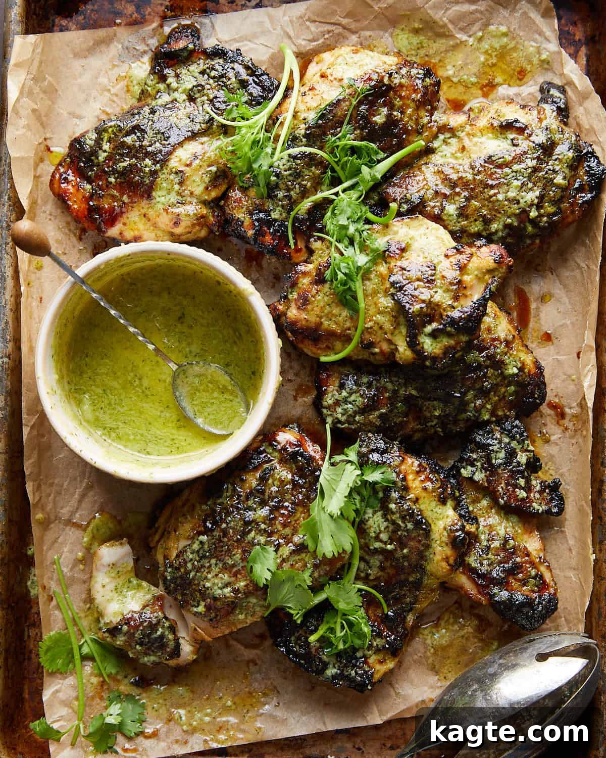Crispy Air Fryer Cilantro Lime Chicken 2 Overhead image of air fryer cilantro lime chicken, garnished with fresh cilantro and lime wedges, on a white plate.