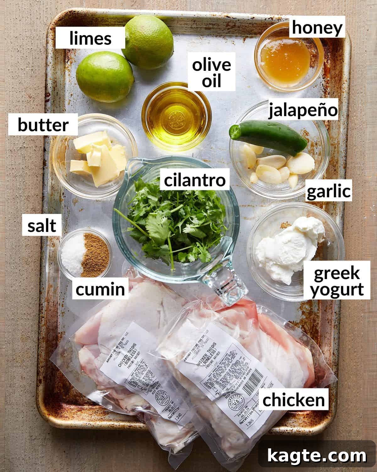 Crispy Air Fryer Cilantro Lime Chicken 3 Overhead image of ingredients needed to make air fryer cilantro lime chicken, including cilantro, limes, garlic, jalapeño, Greek yogurt, and chicken thighs.