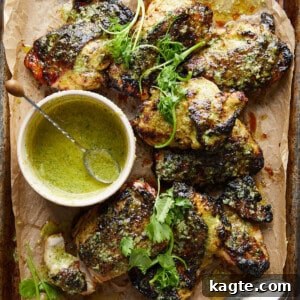 Air Fryer Cilantro Lime Chicken on a white plate with fresh cilantro and lime.
