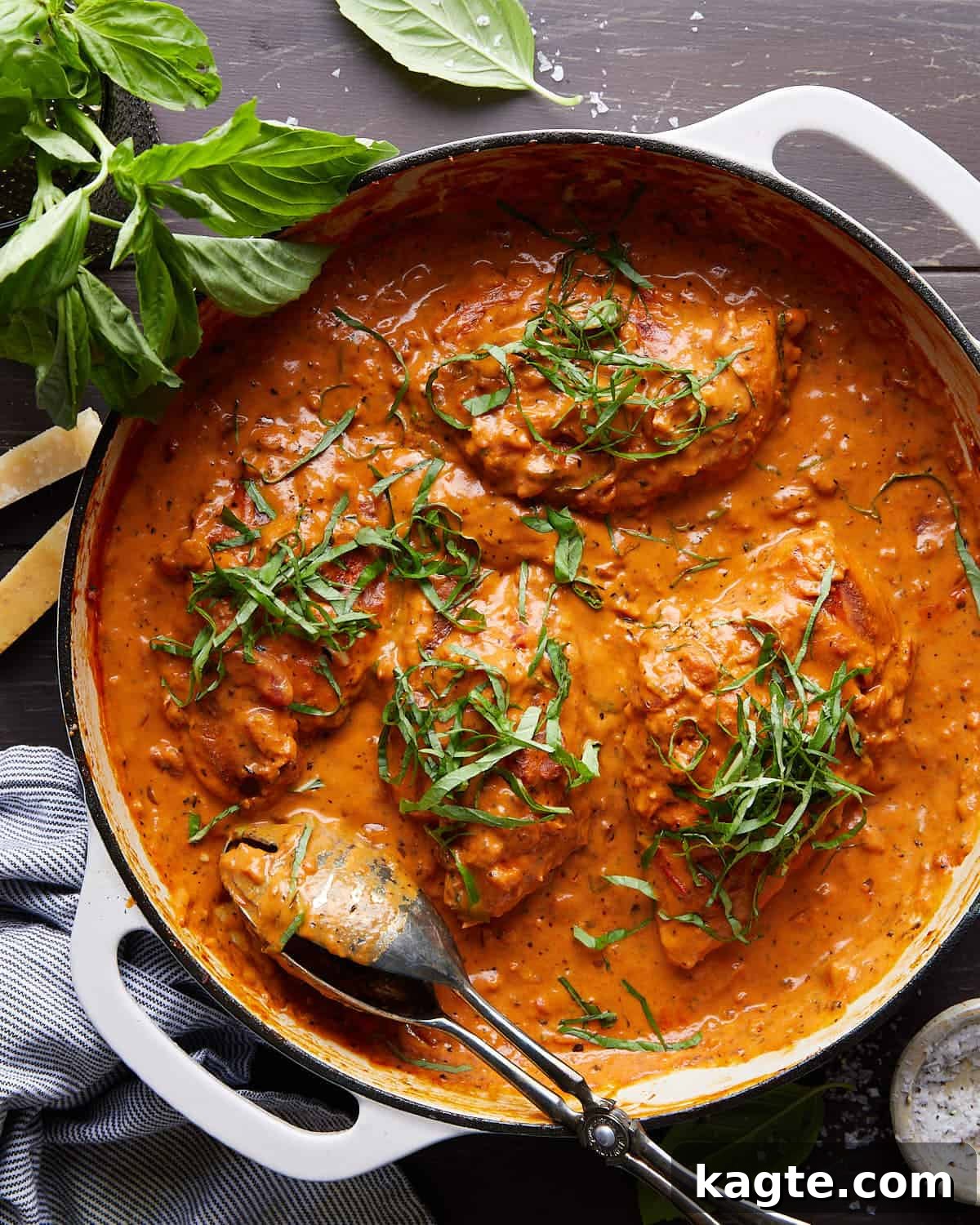 Dreamy Tomato Basil Chicken 2 Overhead image of a beautifully plated creamy tomato basil chicken dish, garnished with fresh basil leaves.
