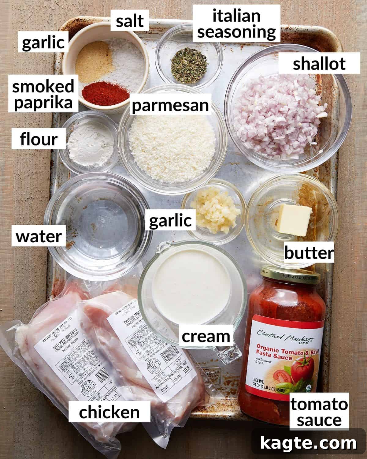 Dreamy Tomato Basil Chicken 3 Overhead image showcasing all the fresh and pantry ingredients required to prepare the creamy tomato basil chicken, neatly arranged on a cutting board.