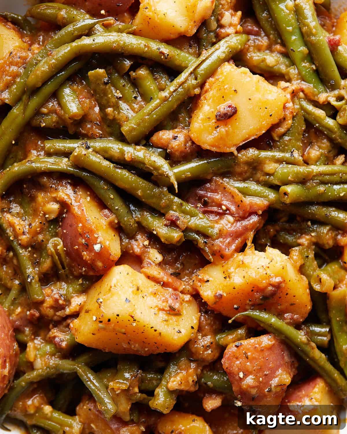 Down-Home Southern Green Beans and Potatoes 5 Up close image of the cooked green beans and potatoes with bacon, highlighting the tender textures and rich sauce.