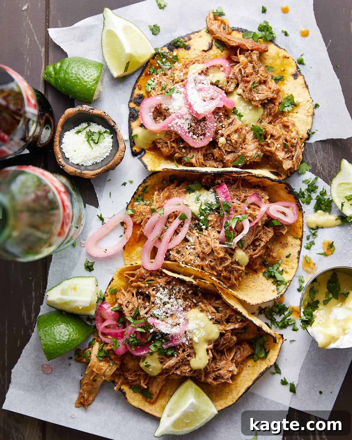 Overhead image of pulled pork street tacos with garnish.