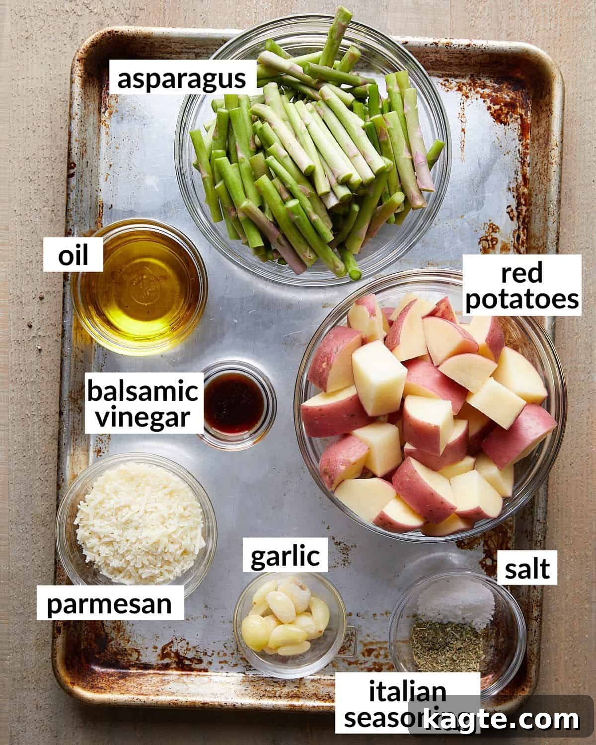 Overhead image of fresh ingredients neatly arranged for roasted potatoes and asparagus recipe.