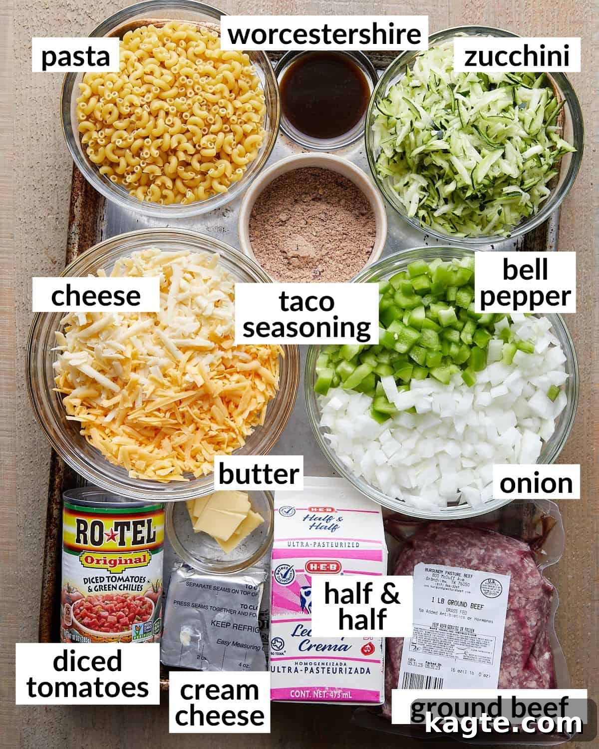 Fiesta Cheesy Taco Pasta Bake 3 Overhead image showing all the fresh ingredients laid out on a table, ready to make taco pasta bake.
