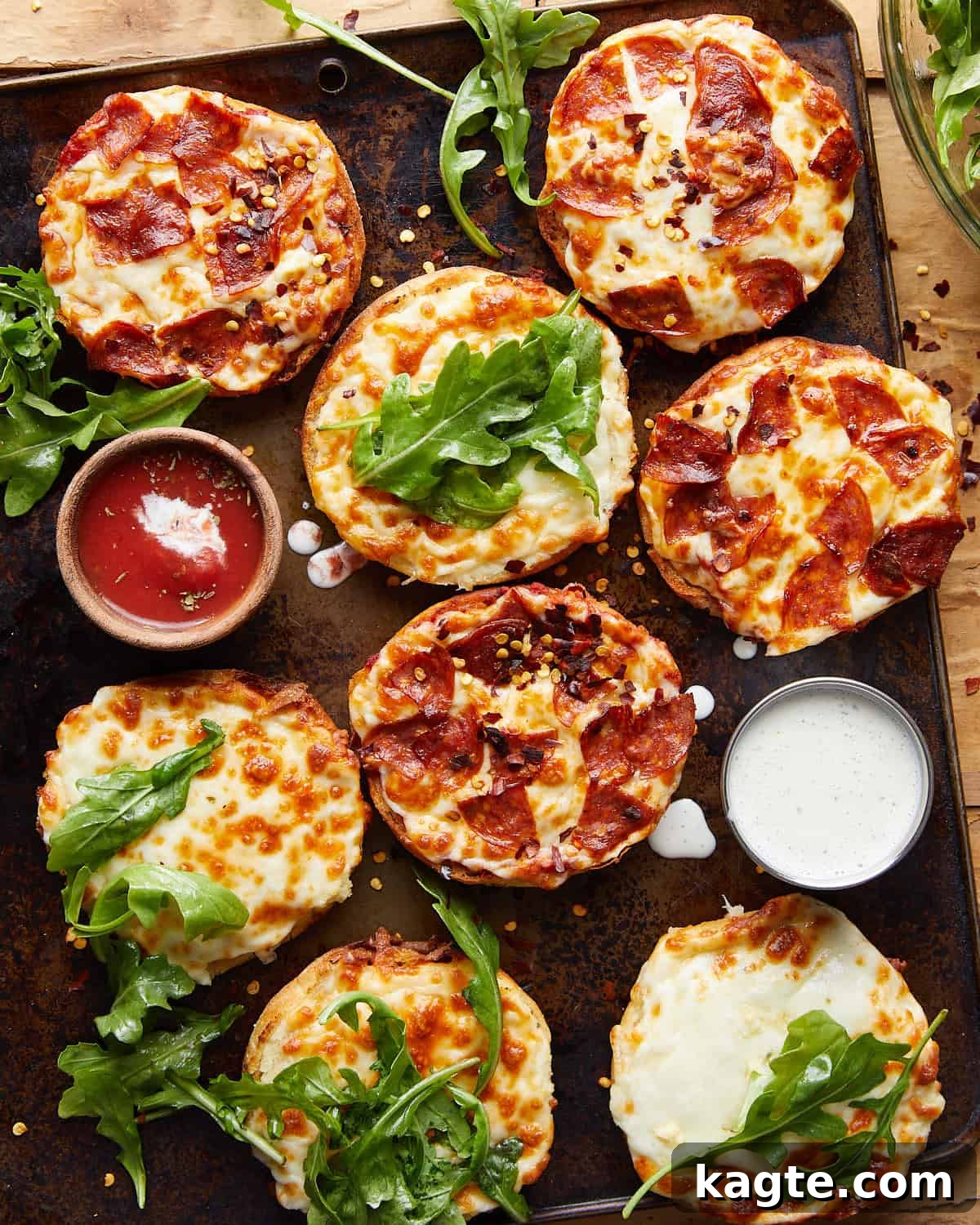 10-Minute Air Fryer English Muffin Pizzas 2 Overhead image of freshly made air fryer English muffin pizzas, garnished with fresh basil.