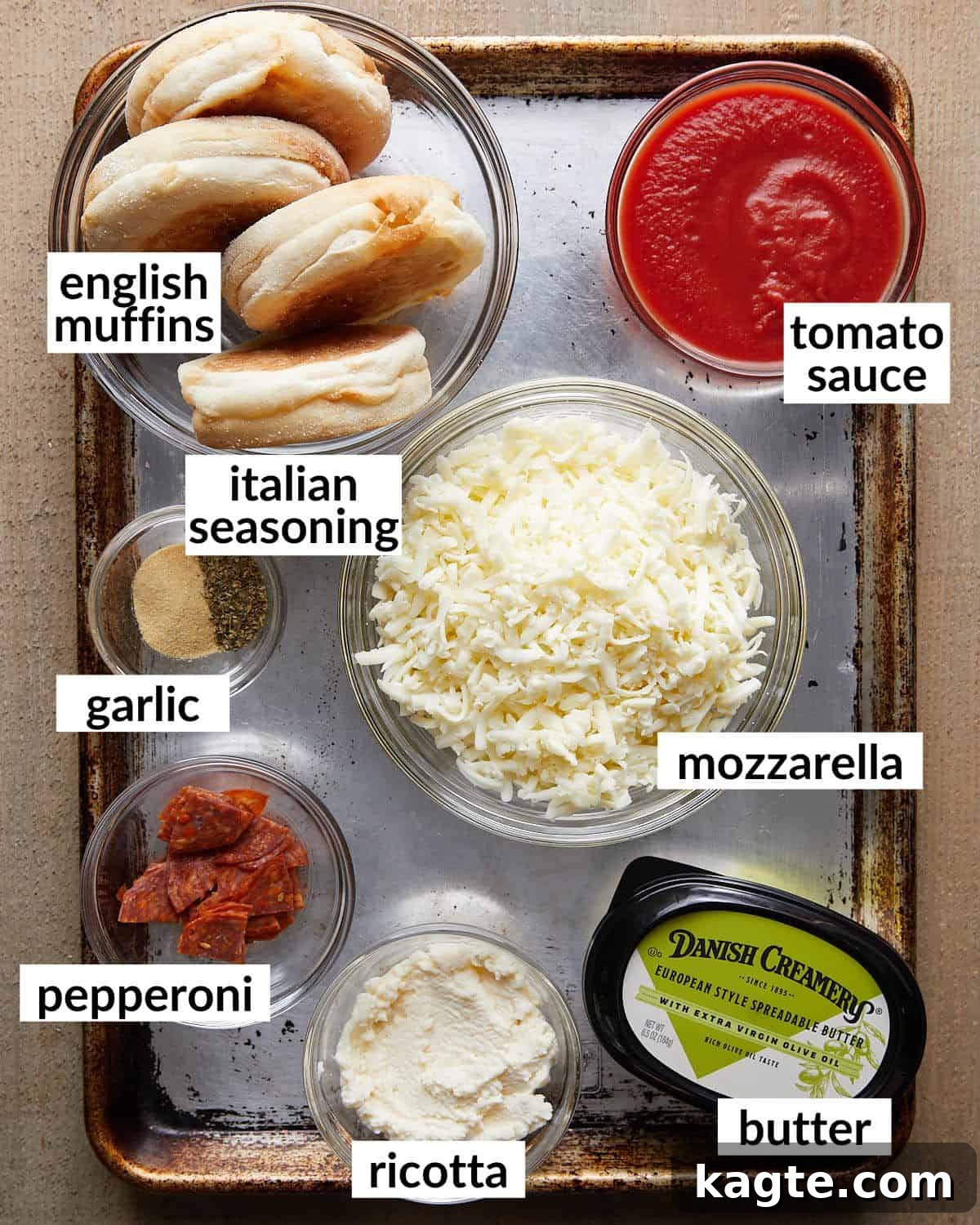 10-Minute Air Fryer English Muffin Pizzas 3 Overhead image of all ingredients for air fryer English muffin pizzas laid out on a counter.