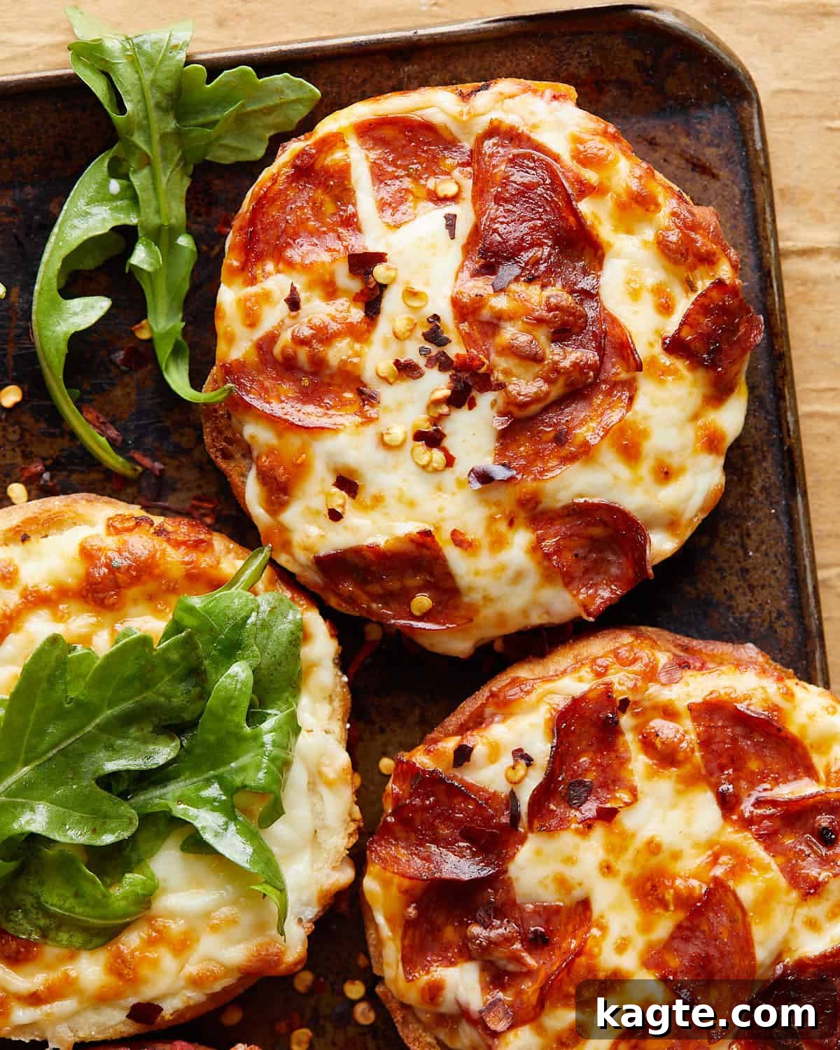 10-Minute Air Fryer English Muffin Pizzas 5 Close-up image of a perfectly cooked air fryer English muffin pizza with melted cheese and pepperoni.