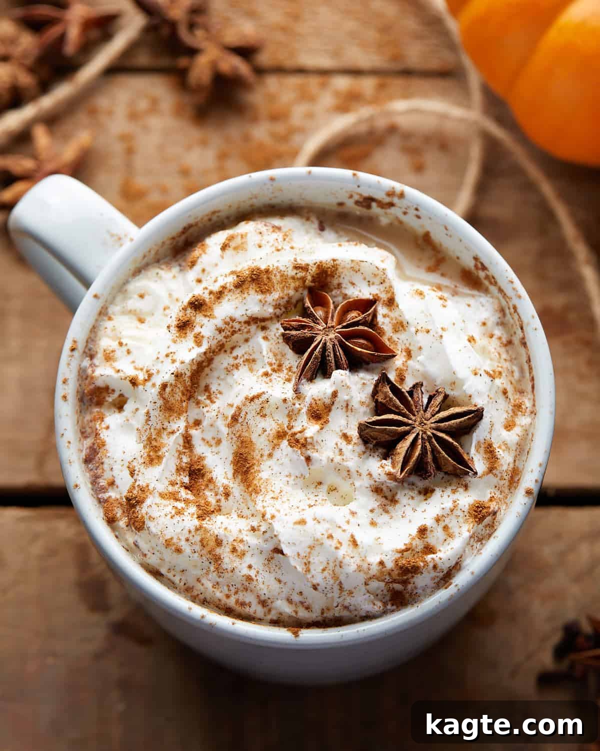 Effortless Pumpkin Spice Chai Latte 5 A close-up image of a pumpkin spice chai latte, showing the creamy foam and a delicate sprinkle of spice on top, with soft, warm lighting.