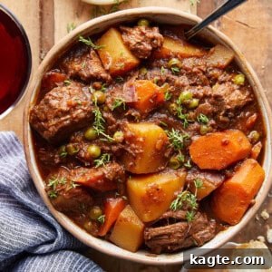 Overhead image of a bowl of old fashioned beef stew with crusty bread.