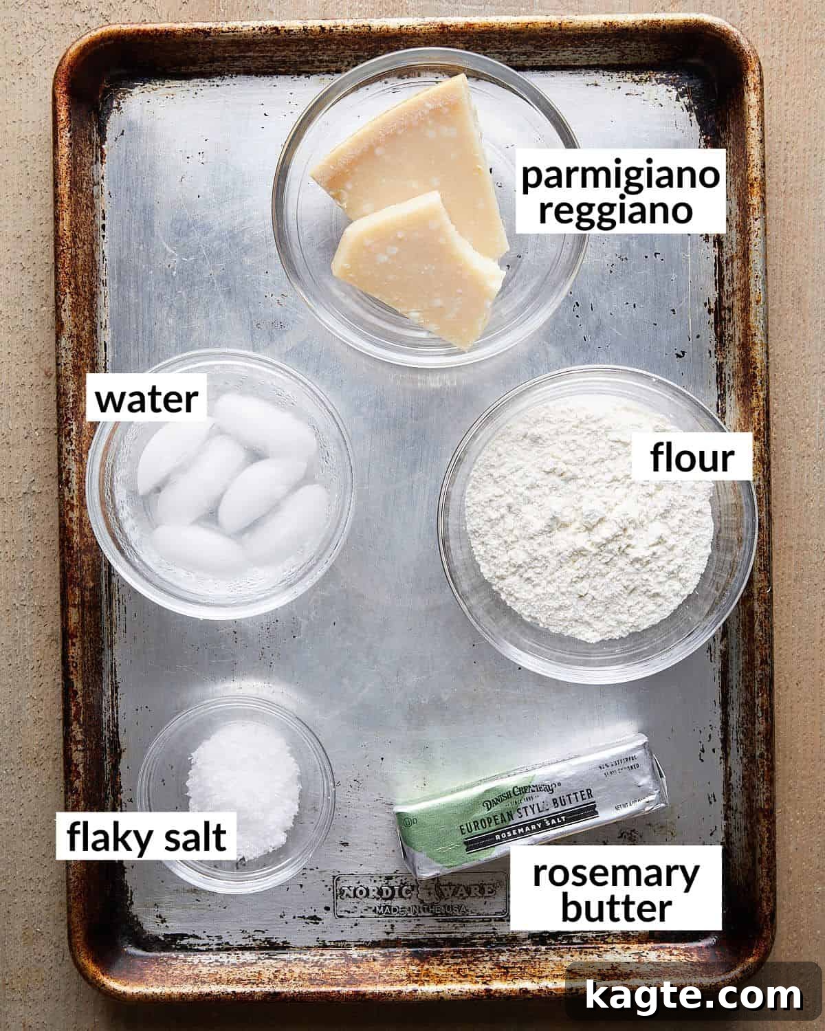 Crispy Parmesan Rosemary Crackers 3 Overhead image of all the ingredients needed to make parmesan rosemary crackers, including Parmesan cheese, flour, butter, and fresh rosemary.