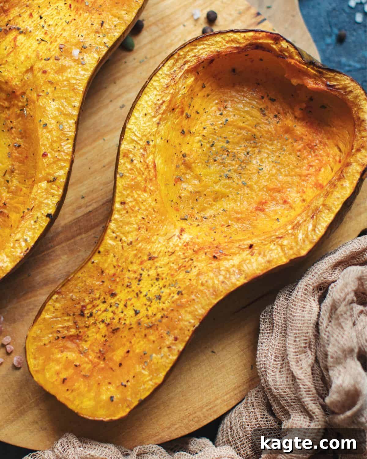 Perfectly Roasted Butternut Squash 2 Overhead image of beautifully baked butternut squash halves, garnished with fresh herbs, ready to be served.