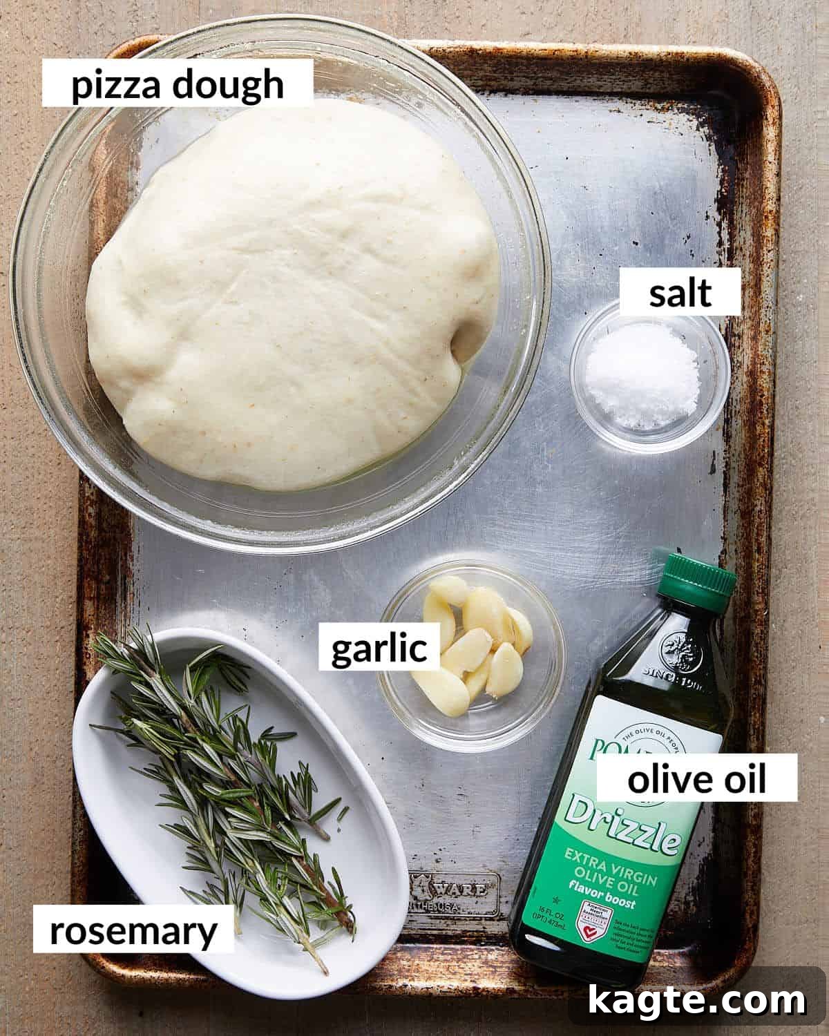Aromatic Garlic Rosemary Focaccia Bites 3 Overhead image of all ingredients needed to make focaccia muffins laid out on a white surface.