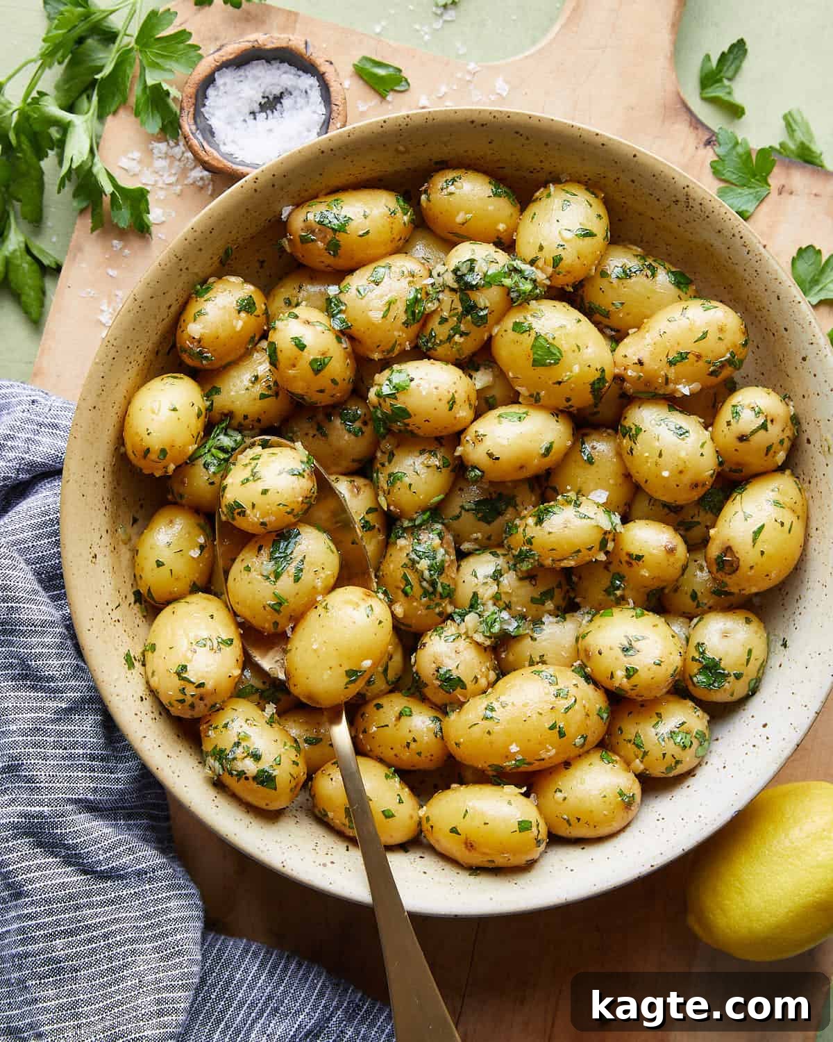 Overhead image of garlic parsley potatoes, glistening with butter and fresh parsley.
