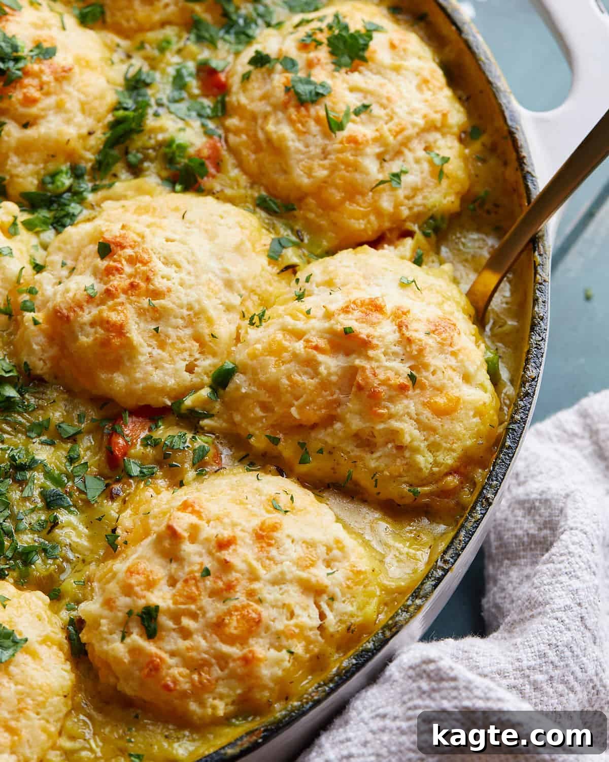 Rustic Dutch Oven Chicken Pot Pie with Fluffy Biscuit Topping 5 Up close photo of chicken pot pie with cheddar biscuit topping.