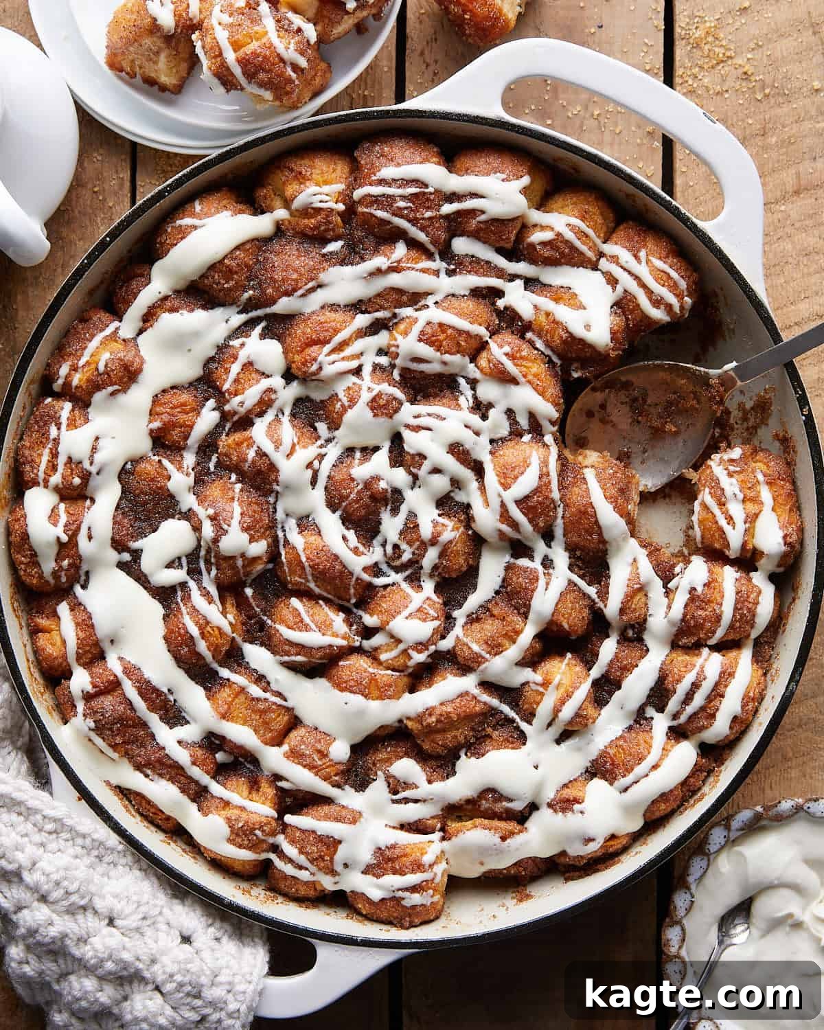 Overhead image of freshly baked Dutch oven monkey bread, golden brown and drizzled with a creamy glaze.