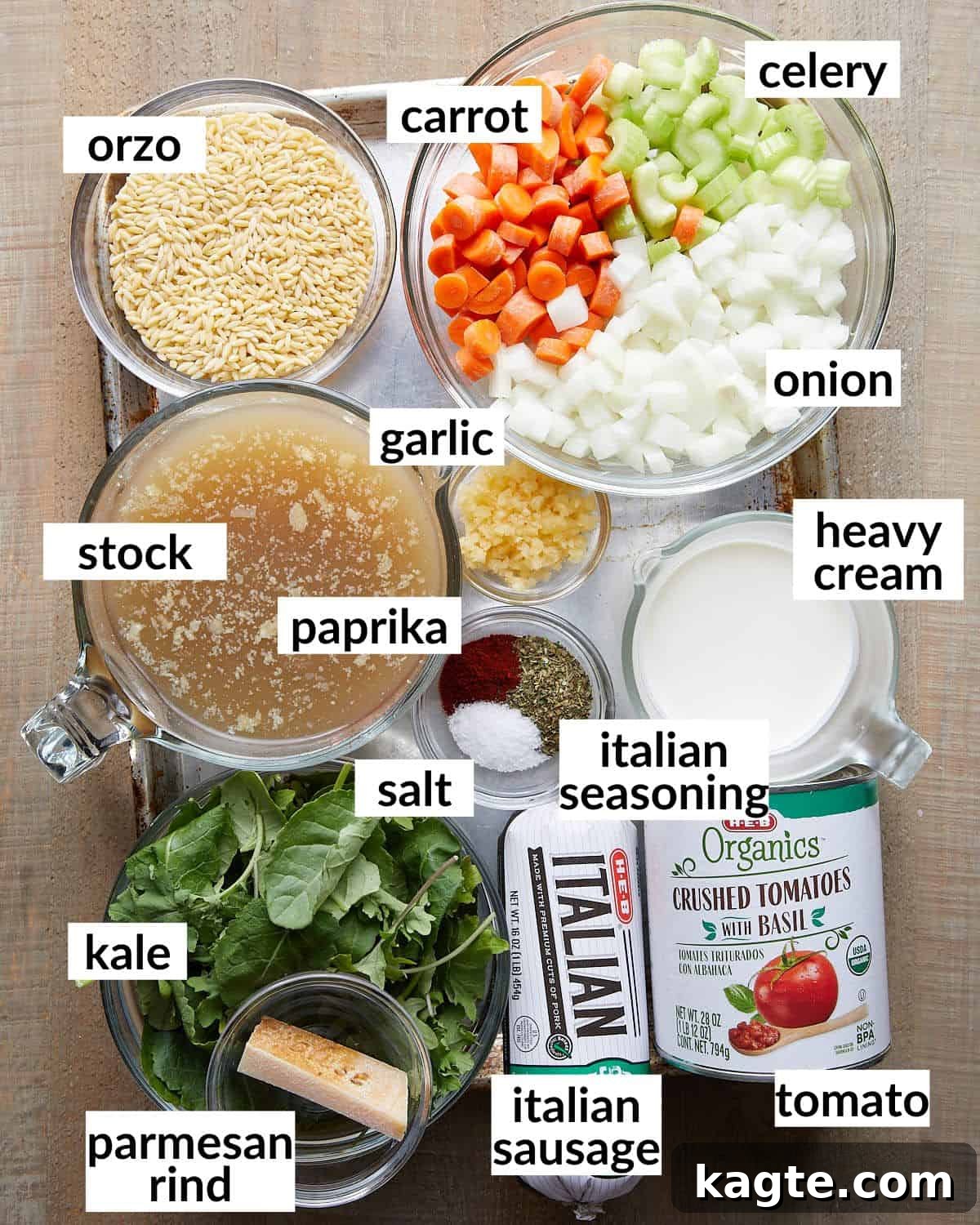 Hearty Creamy Italian Sausage Soup with Orzo and Kale 3 Overhead image of all fresh ingredients laid out for making creamy Italian sausage soup, including sausage, vegetables, and seasonings.