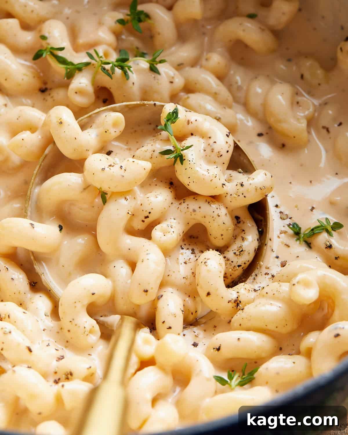 Up close image of Dutch oven mac and cheese with garnish, highlighting its cheesy texture.