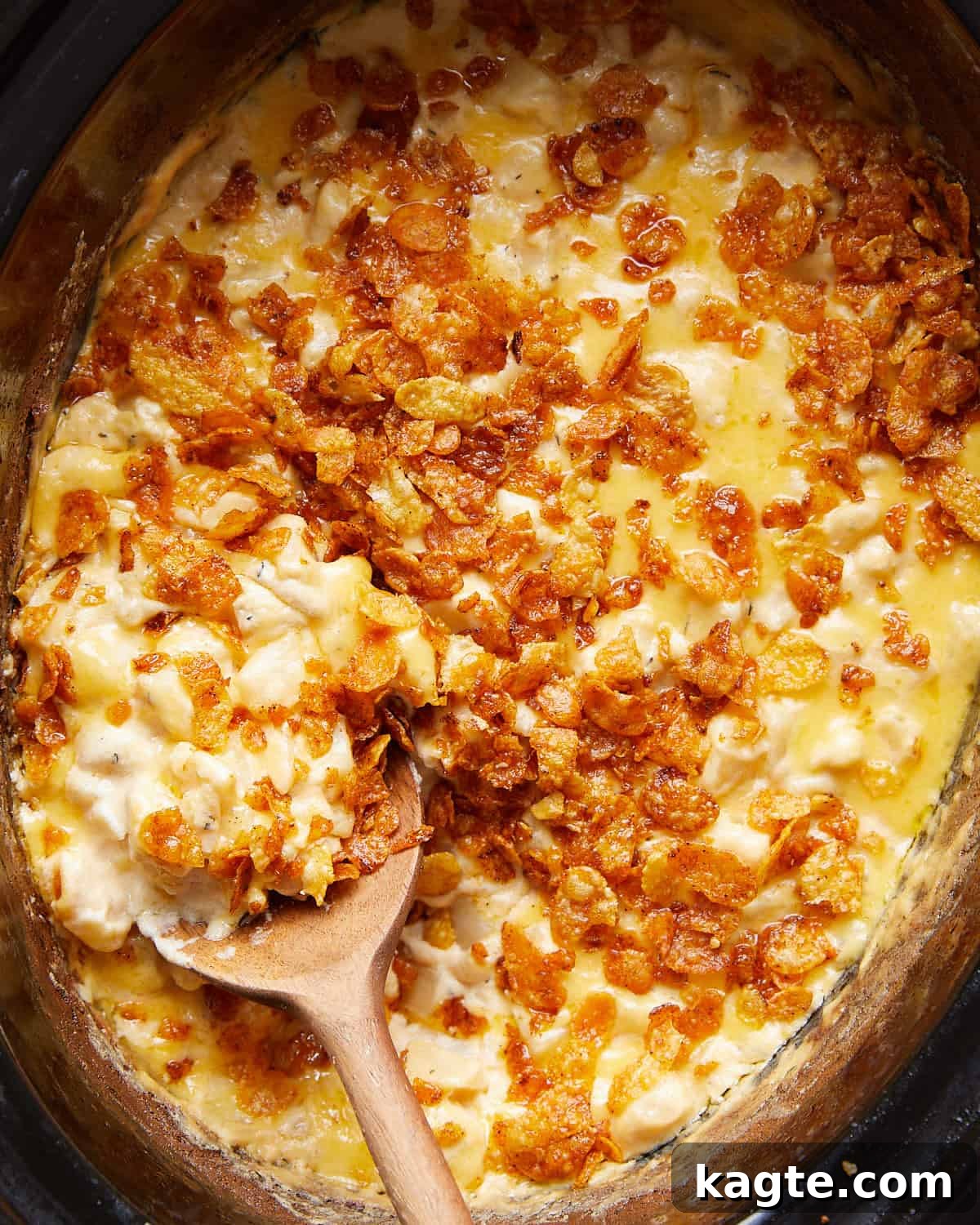 From Scratch Slow Cooker Cheesy Hash Brown Casserole 4 Overhead close-up shot of the finished crockpot funeral potatoes, showing the melted cheese and crispy cornflake topping, ready to be served.