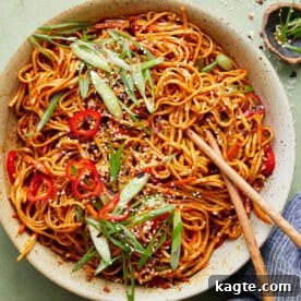 Close-up image of savory chili garlic noodles, showcasing their glossy texture and flavorful coating.