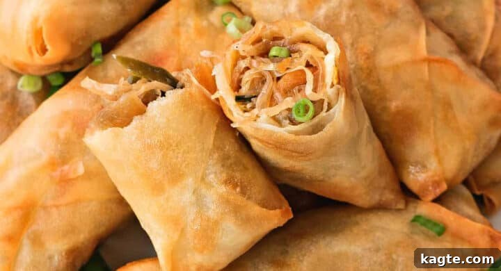 Close-up image of golden, crispy vegetarian spring rolls, ready to be dipped.