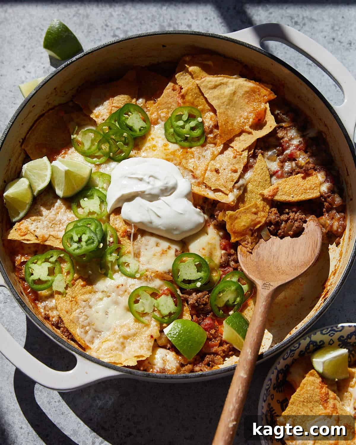 Simple Crispy Beef Taco Bake 2 Overhead image of beef taco casserole with garnish, showcasing its cheesy, layered texture.