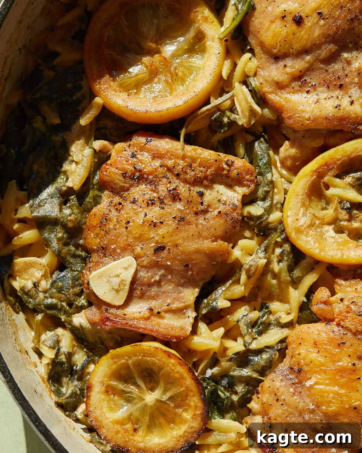 One-Pan Zesty Lemon Chicken Orzo 6 A beautiful, close-up, and inviting image of creamy lemon chicken and orzo pasta, showing the tender chicken, orzo, and wilted spinach.
