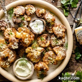 Crispy smashed potatoes in an air fryer, seasoned with garlic parmesan herb butter