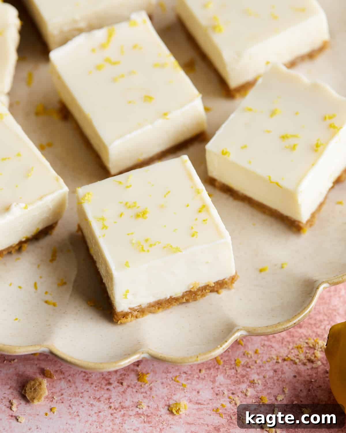 Zesty Lemon Bars With Graham Cracker And Condensed Milk Perfection 6 Overhead image of lemon bars with graham cracker crust on white plate.