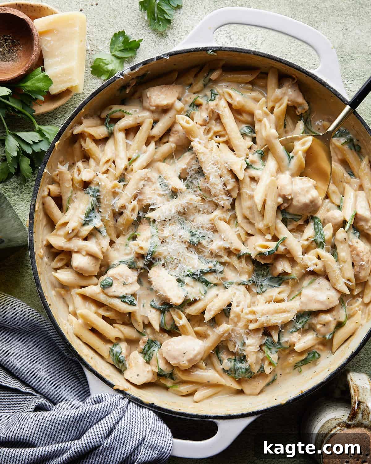 Overhead image of garlic chicken pasta with garnish. 