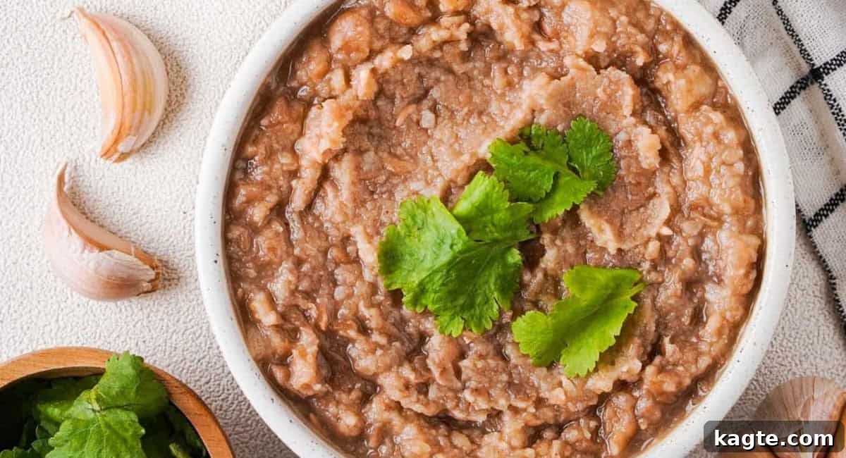 Overhead image of refried beans with garnish. 