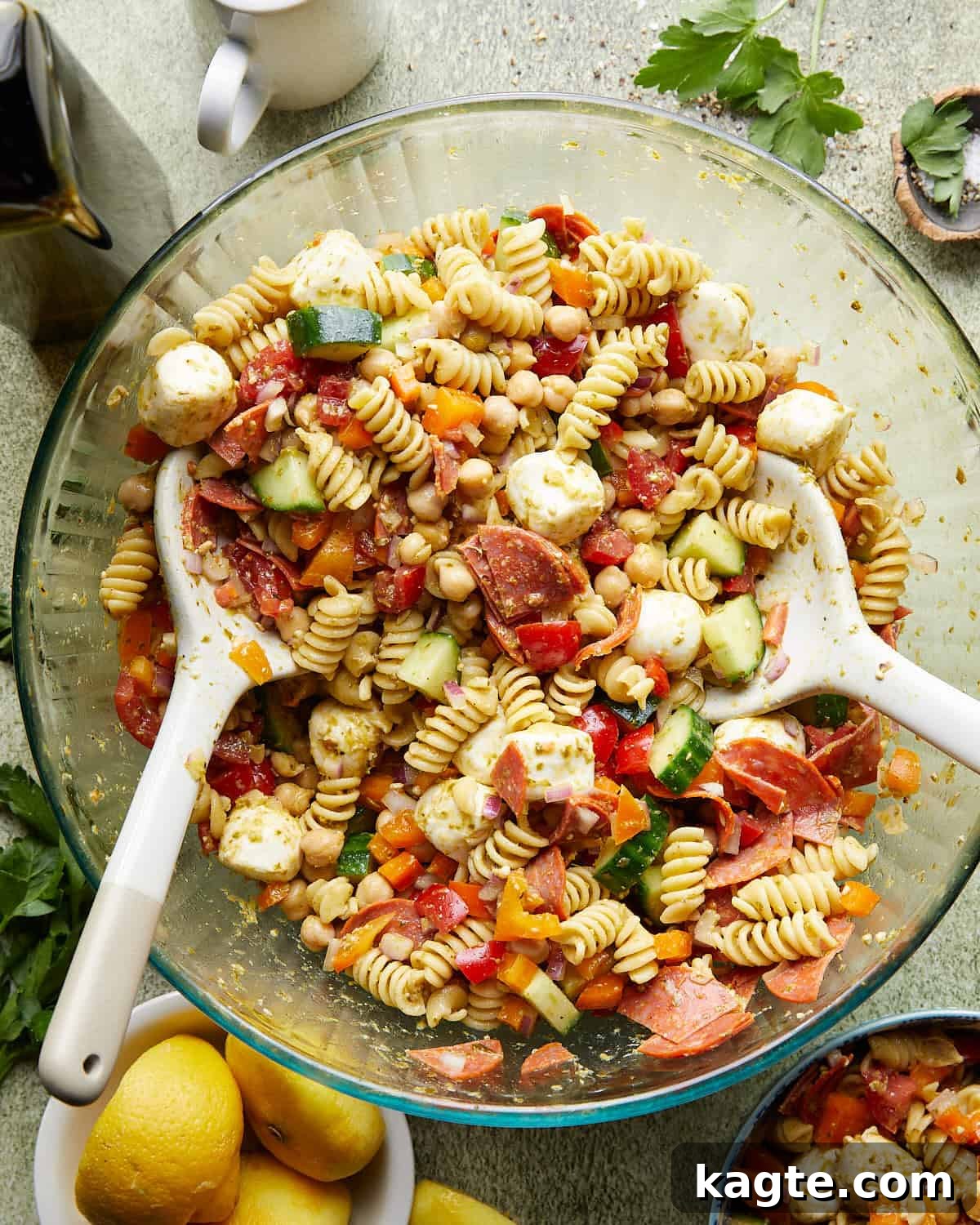 Zesty Italian Pasta Salad 2 Overhead image of healthy Italian pasta salad in a large serving bowl, garnished with fresh herbs.