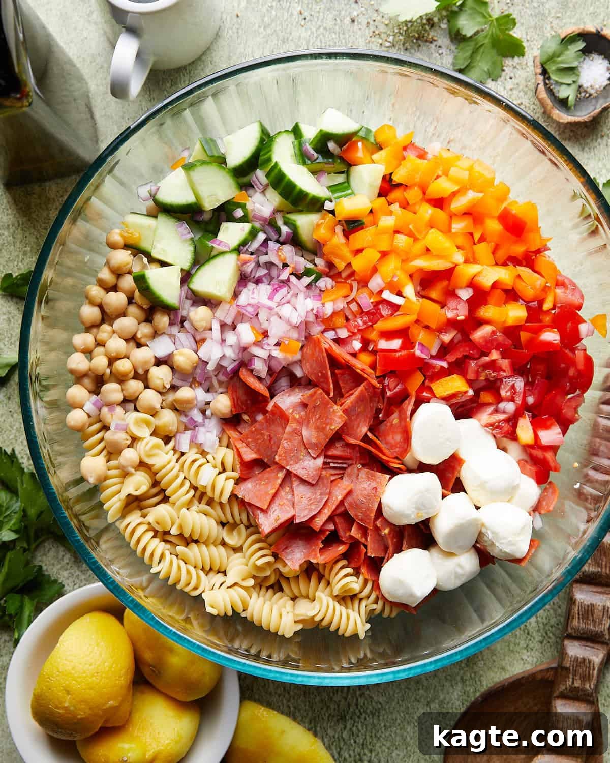 Zesty Italian Pasta Salad 5 Close-up overhead shot of a healthy Italian pasta salad in a white bowl, showing all ingredients mixed and coated with dressing.