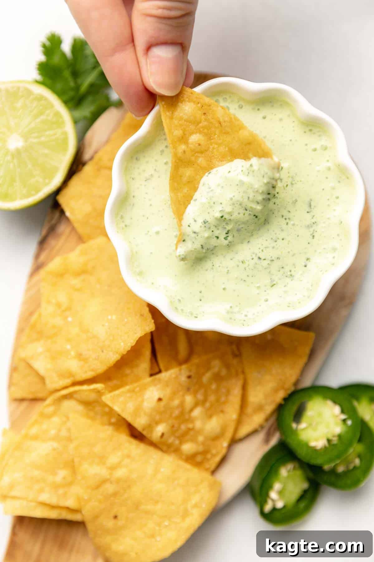 Zesty Jalapeño Lime Crema 5 Crispy tortilla chip generously loaded with creamy Jalapeño Lime Crema, showcasing the perfect texture for dipping.