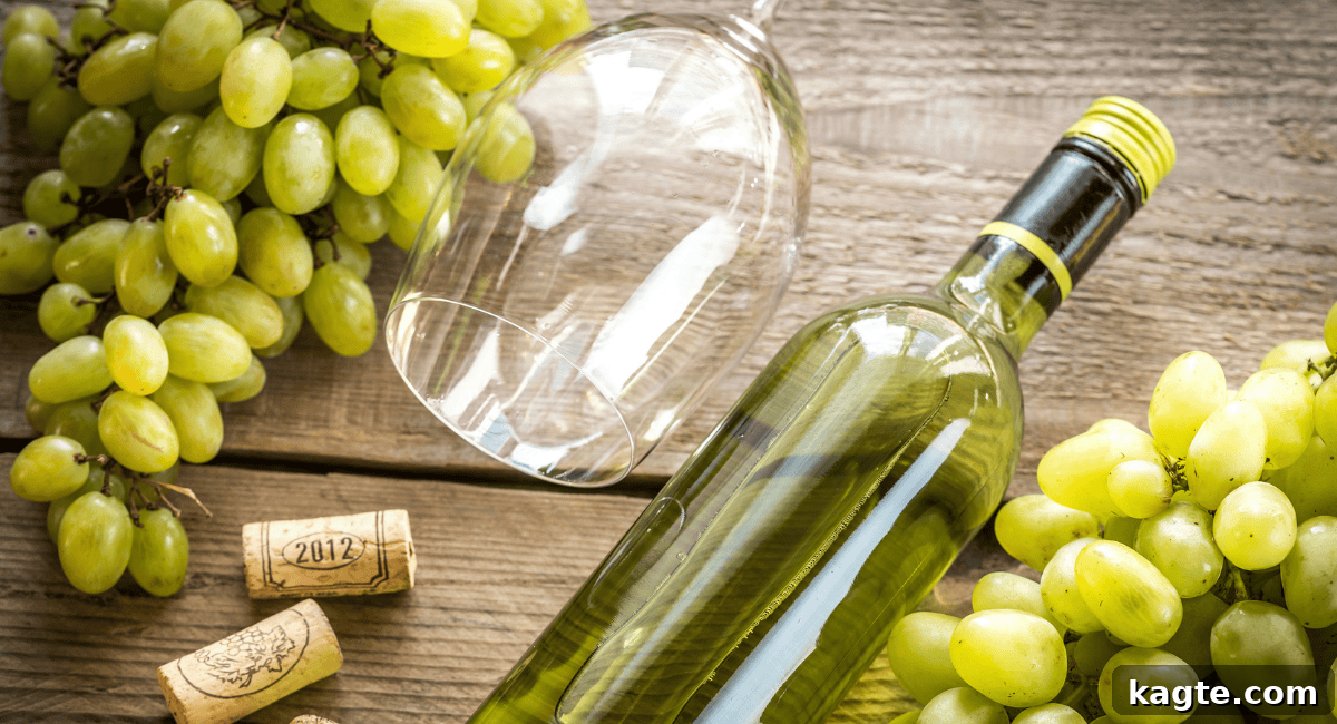 8 Smart Substitutes for Shaoxing Wine 6 Overhead shot of a glass of dry white wine next to a bottle, emphasizing its crisp, clear appearance.