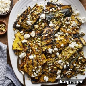 The Best Grilled Zucchini and Yellow Squash Recipe, garnished with feta and pistachios.