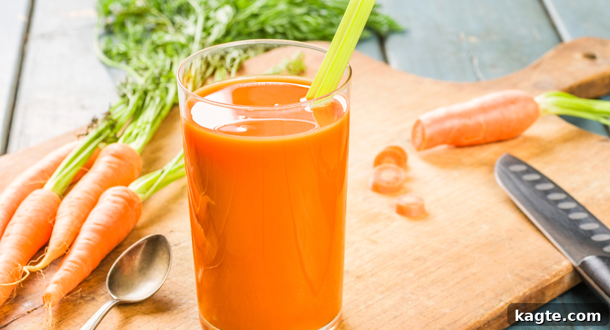Top 12 Orange Juice Substitutes for Cooking and Baking 14 Close-up image of a glass of fresh, vibrant carrot juice, with whole and sliced carrots arranged in the background, suggesting natural goodness.