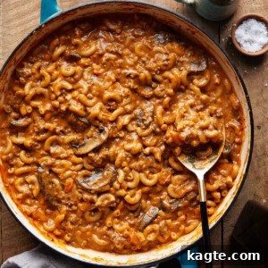 Homemade Hamburger Helper with a spoon scooping a portion out of a bowl.