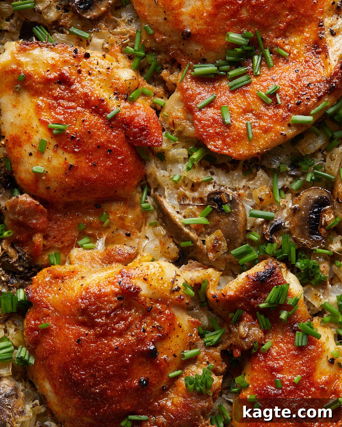 Hearty One-Pot Chicken and Rice Bake 5 Up close image of oven baked chicken and rice with garnish.