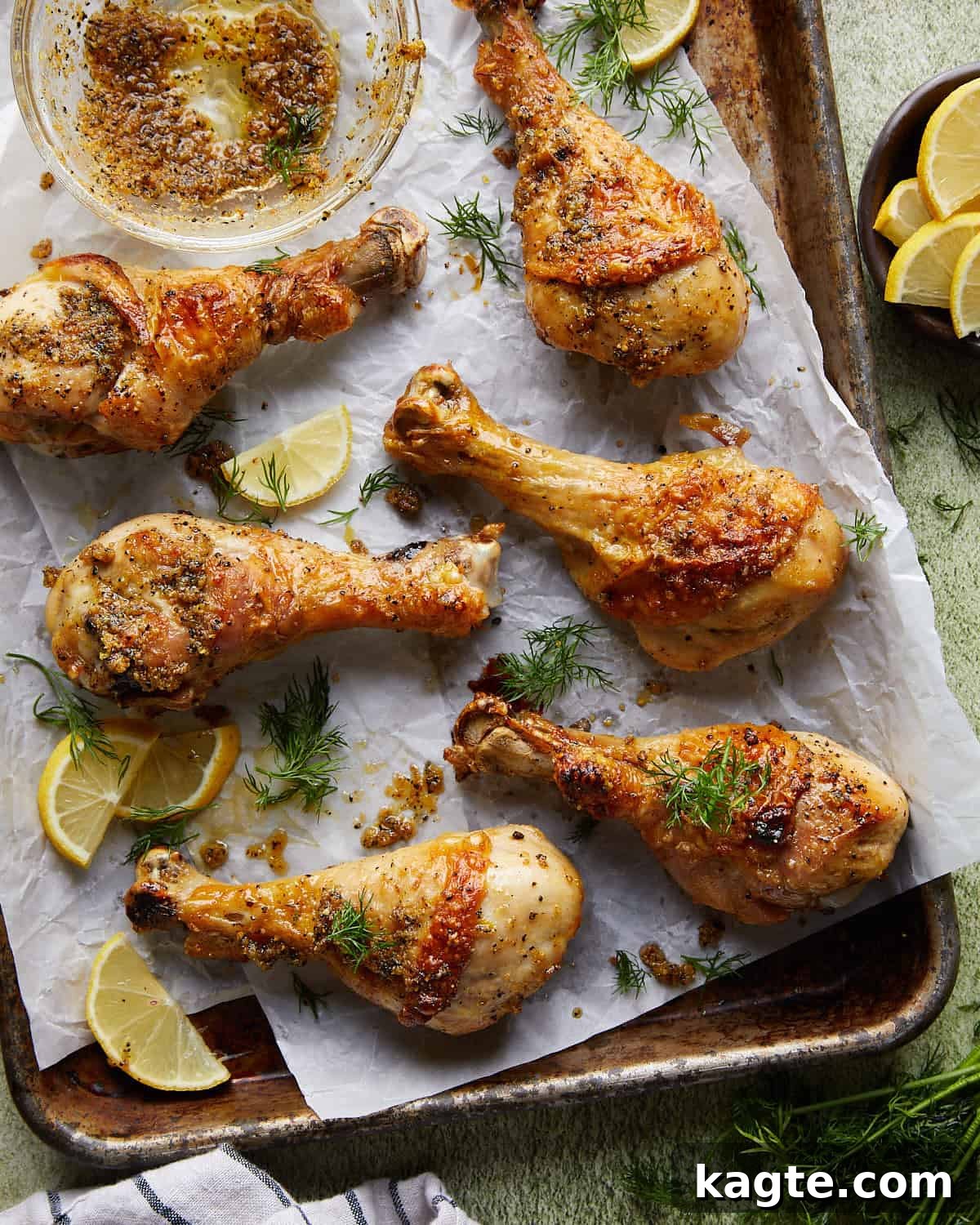 Crispy Oven Roasted Lemon Pepper Drumsticks 2 Overhead image of beautifully golden-brown and crispy lemon pepper chicken drumsticks, garnished with fresh parsley and lemon wedges.