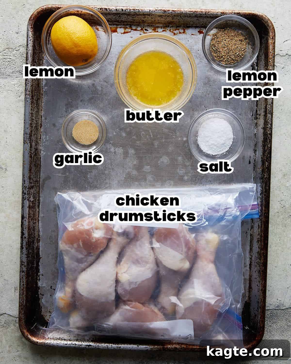 Crispy Oven Roasted Lemon Pepper Drumsticks 3 Overhead image showing all the fresh ingredients laid out on a table, including lemons, butter, garlic, and chicken drumsticks, ready for making lemon pepper chicken.