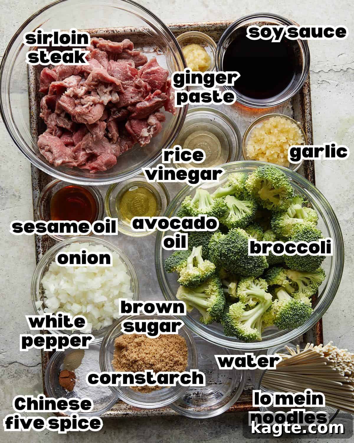 An overhead shot showcasing all the fresh ingredients for a Beef and Broccoli Noodles recipe, neatly arranged.