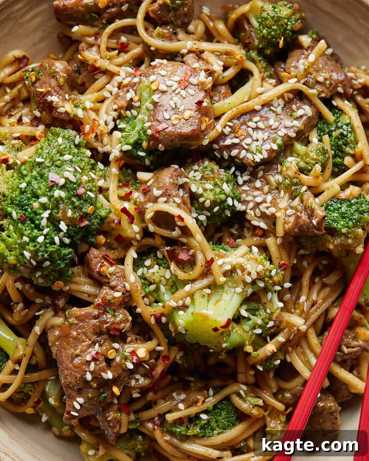 A close-up, appetizing image of Beef and Broccoli Noodles, showing the glossy sauce coating each ingredient.