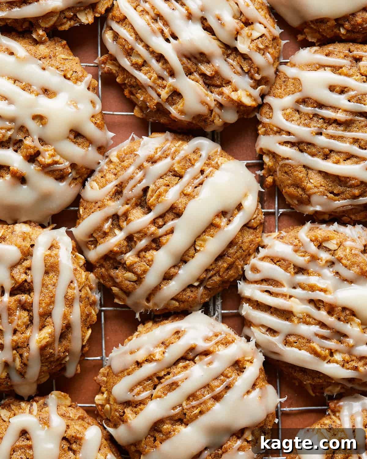 Spiced Chewy Pumpkin Oat Cookies 6 Up close image of pumpkin oatmeal cookies with cream cheese frosting, showing the texture and glaze.