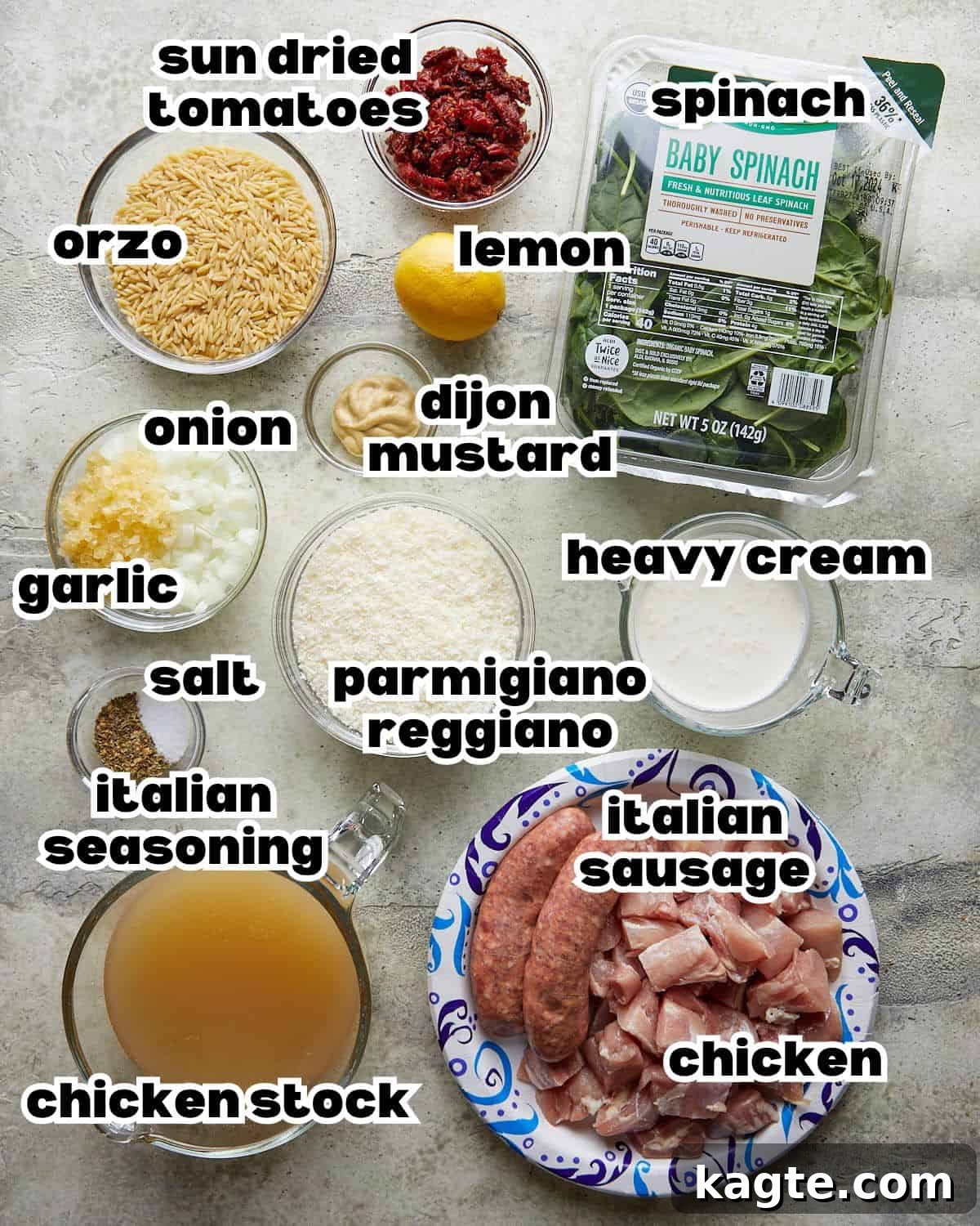 Creamy Tuscan Chicken Orzo Casserole 3 Overhead image of fresh ingredients for chicken and orzo bake including chicken, spinach, orzo, and sun-dried tomatoes.